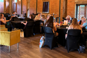People working on yarn and fiber projects together during a Brazos Valley Fiber Arts gathering at the Kimbell Cultural Event Center in downtown Bryan, Texas